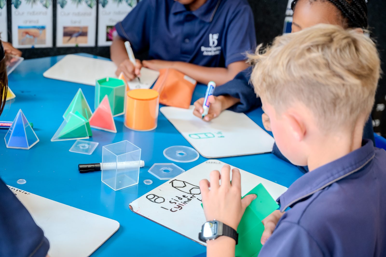 Junior Prep students working with geometric shapes at a classroom table